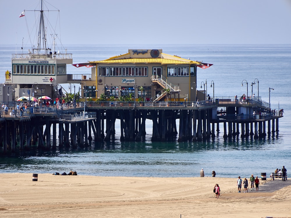 a pier with people on it and a building in the background