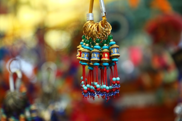 Close-up of colorful handcrafted trinkets arranged neatly on a shelf.