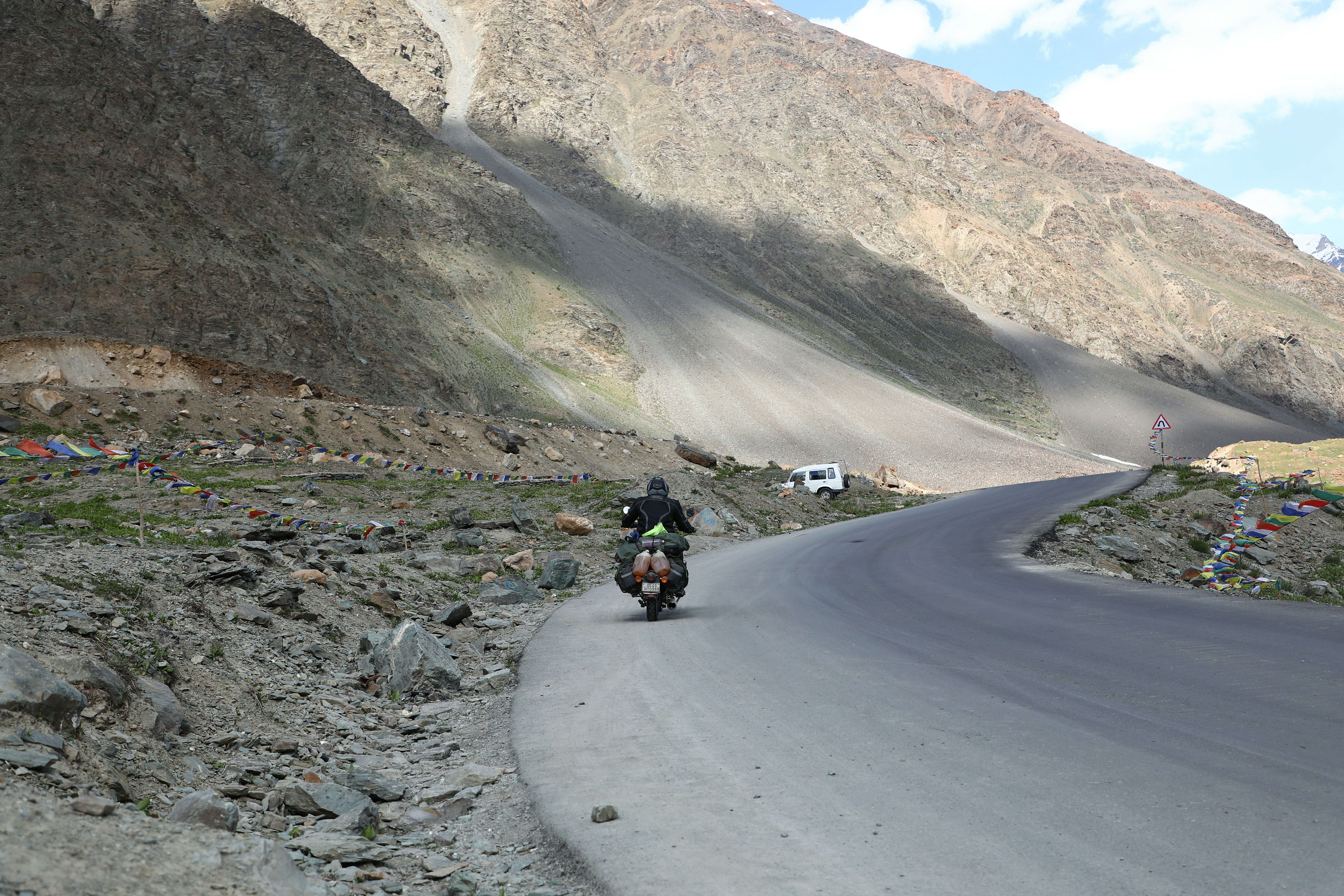 a man riding a motorcycle on a road