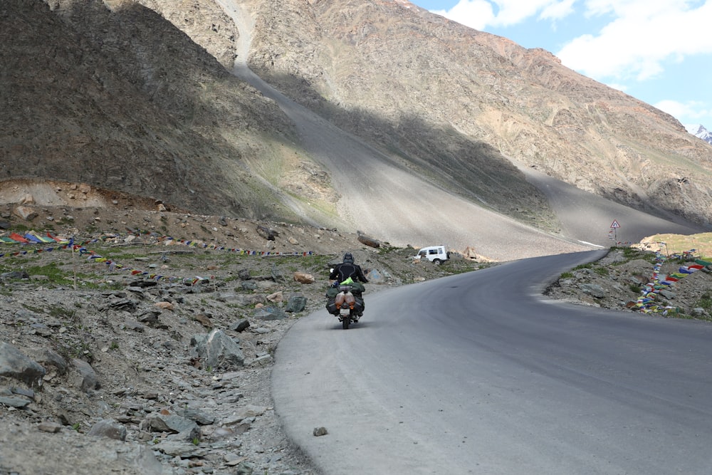 a man riding a motorcycle on a road