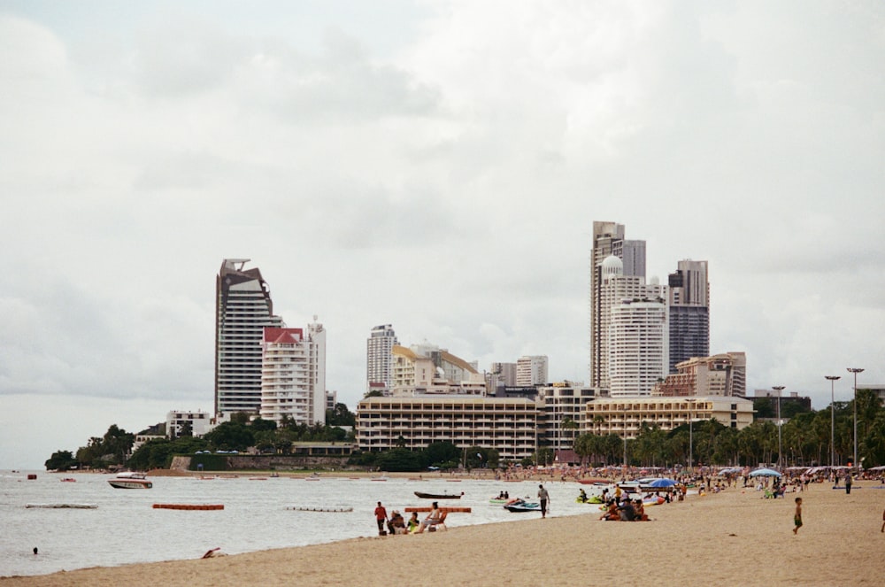 a beach with people and buildings in the background