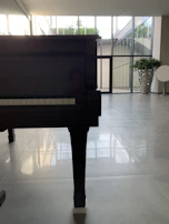 An elegant grand piano with polished wood reflecting the room's warm glow.