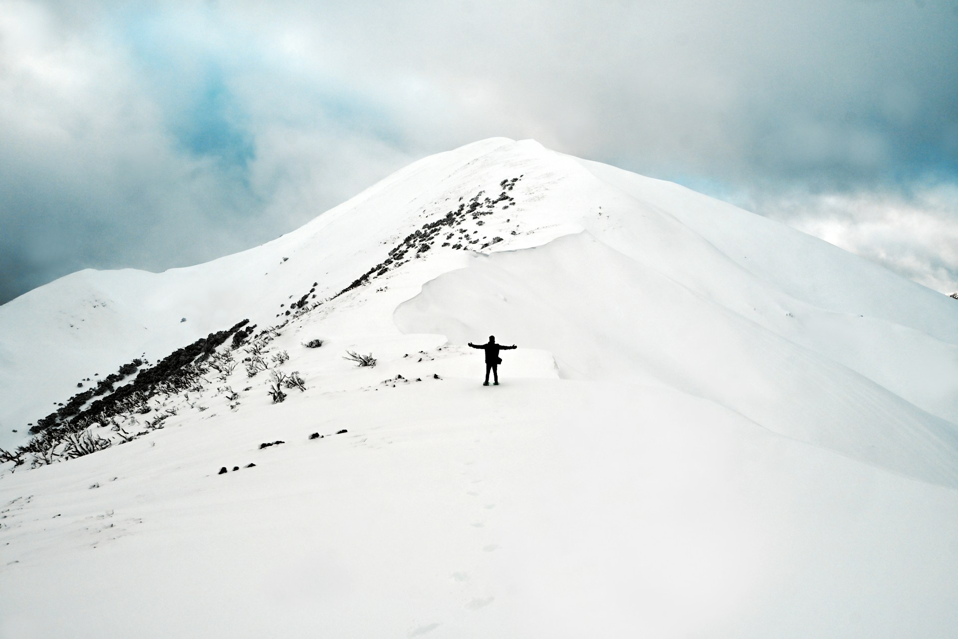a person walking up a snowy mountain