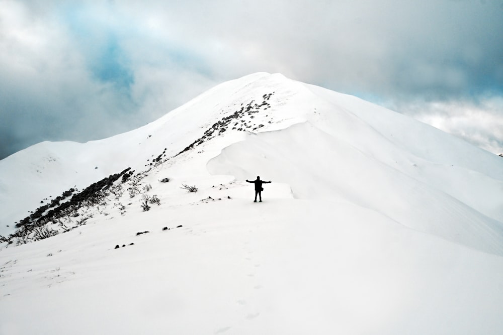 a person walking up a snowy mountain