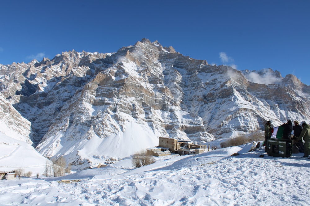 a group of people standing on a snowy mountain