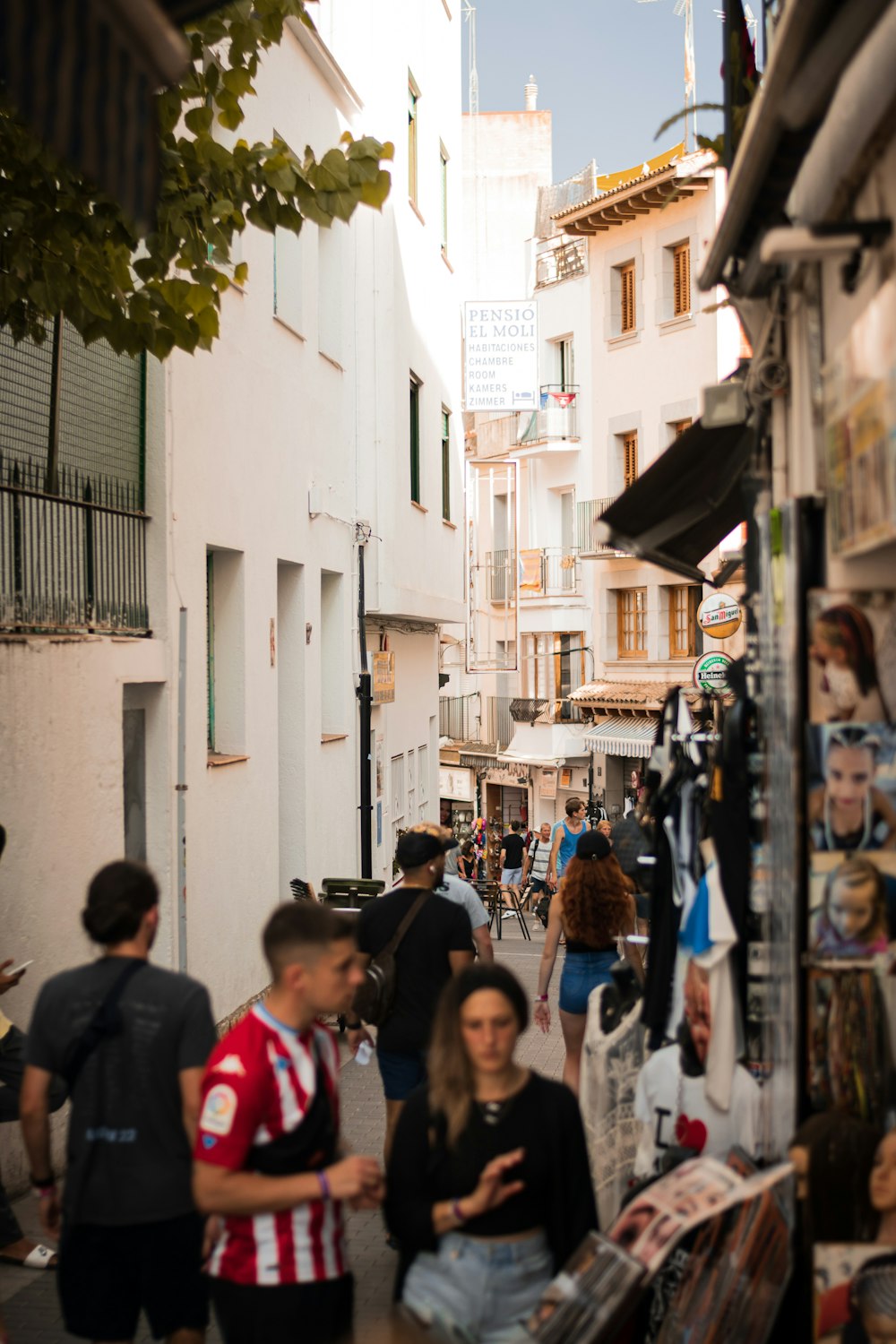 a group of people walking down a narrow street