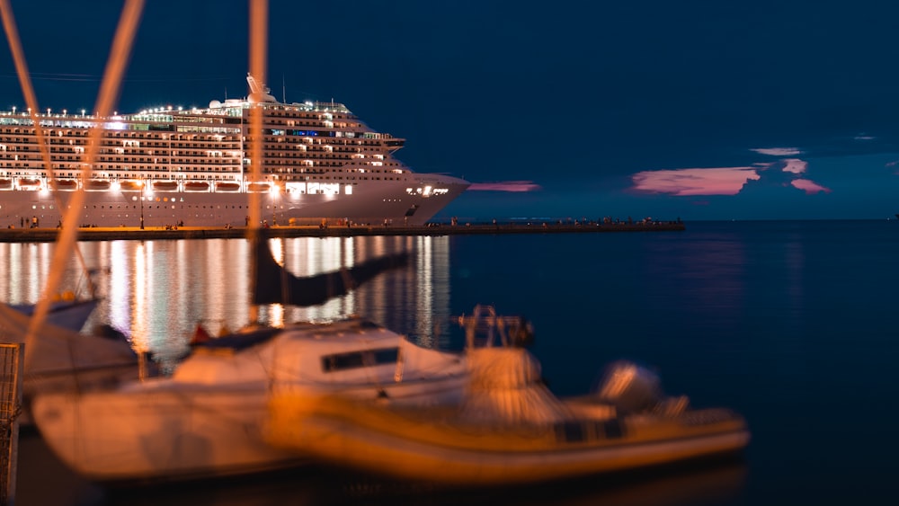 a boat in the water with a large ship in the background