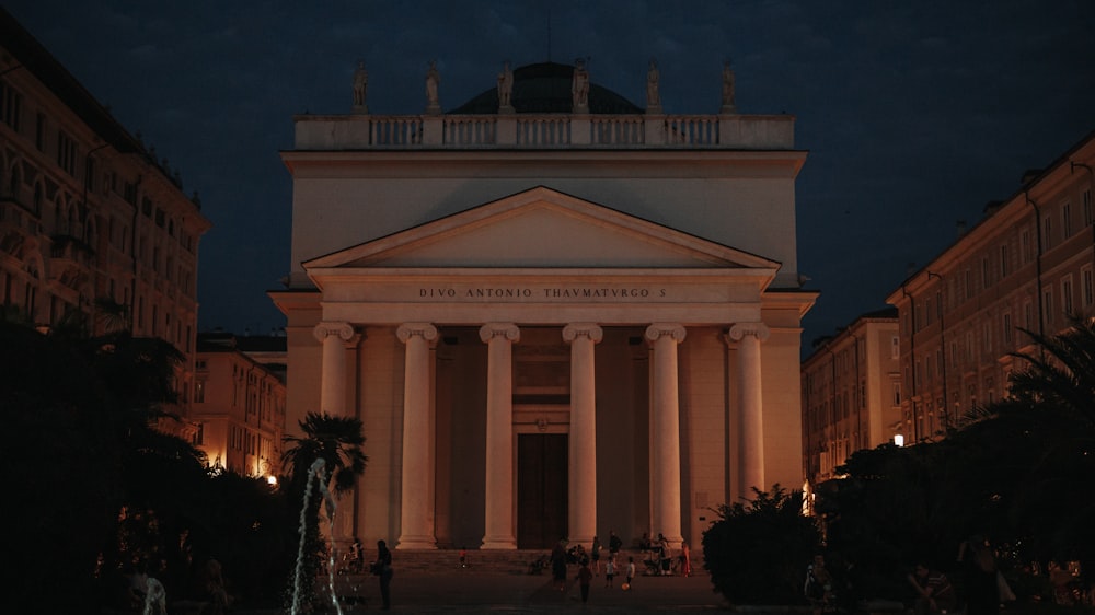 a large white building with columns at night
