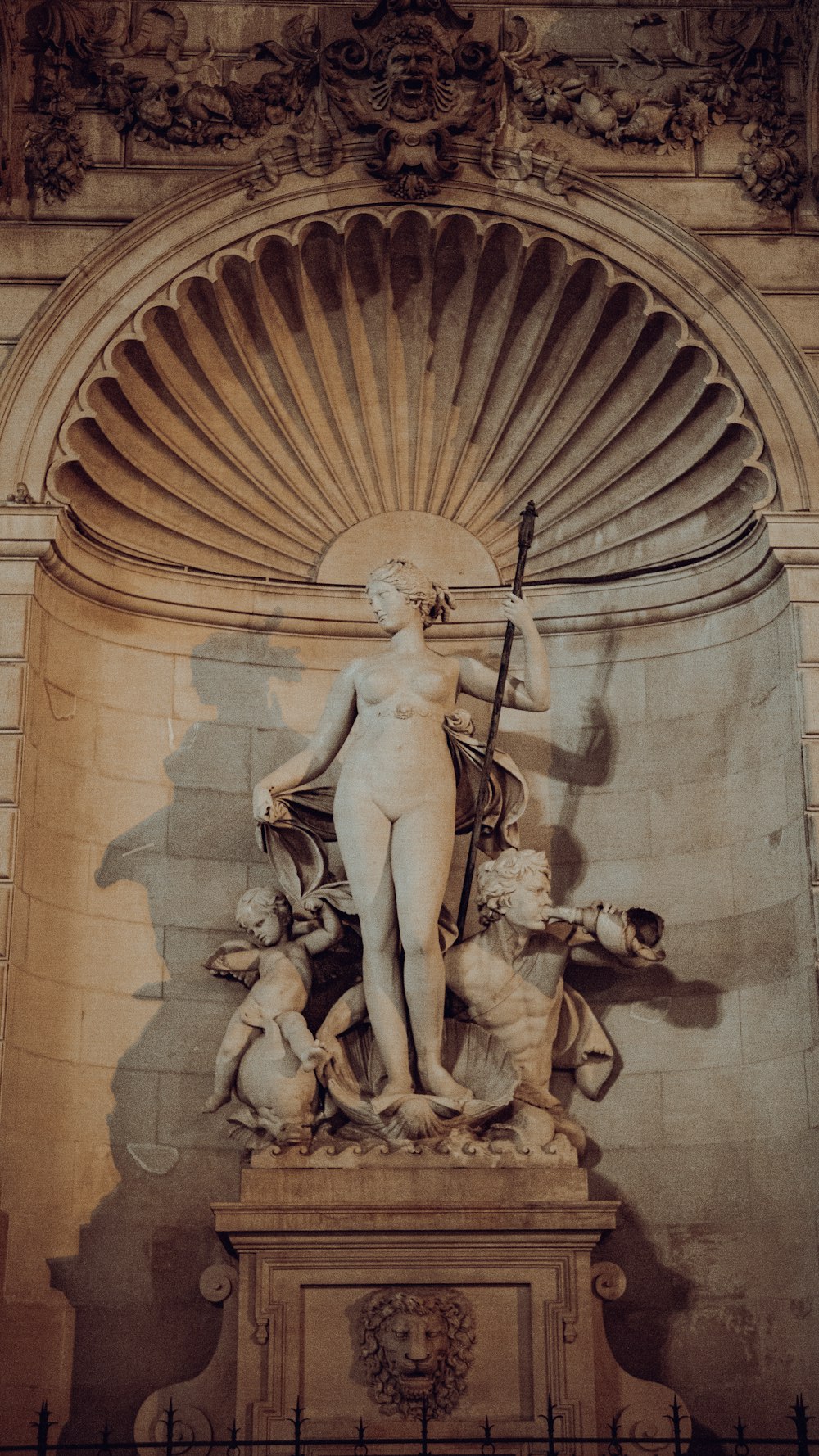 a statue of a person holding a staff