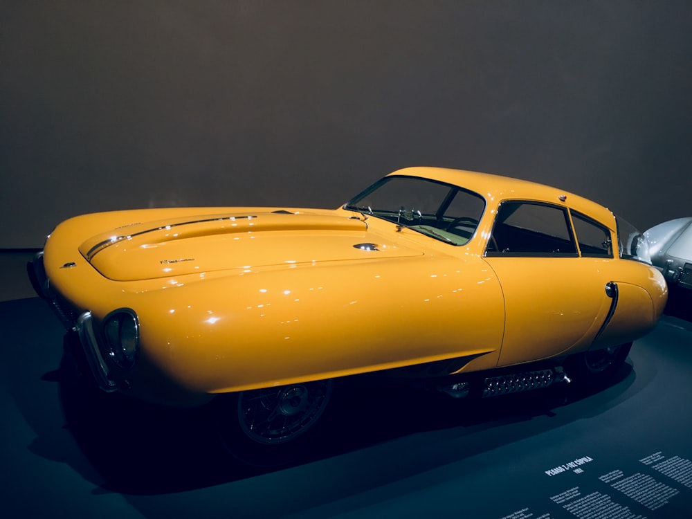 a yellow car on a black surface