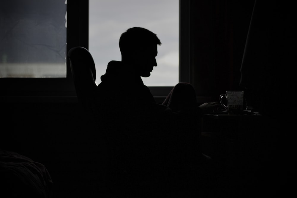 a person sitting in a dark room