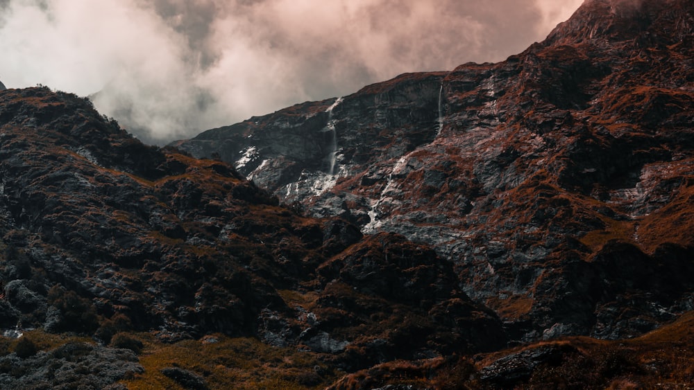 a rocky mountain with clouds