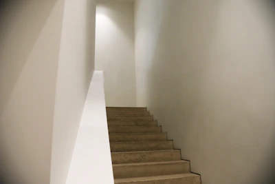 softly lit staircase with clean lines and a quiet luxury aesthetic in muted tones