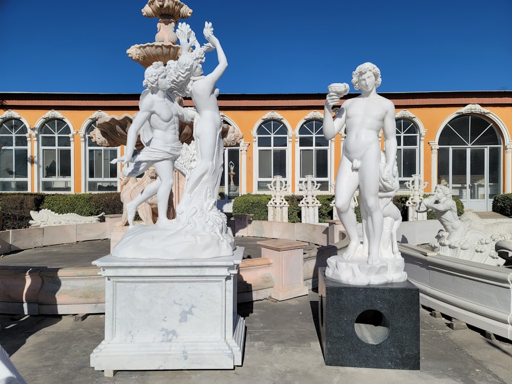 a group of statues outside of a building