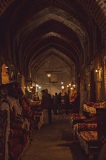 A smiling concierge guiding a small group through the vibrant souks of Marrakech at sunset.