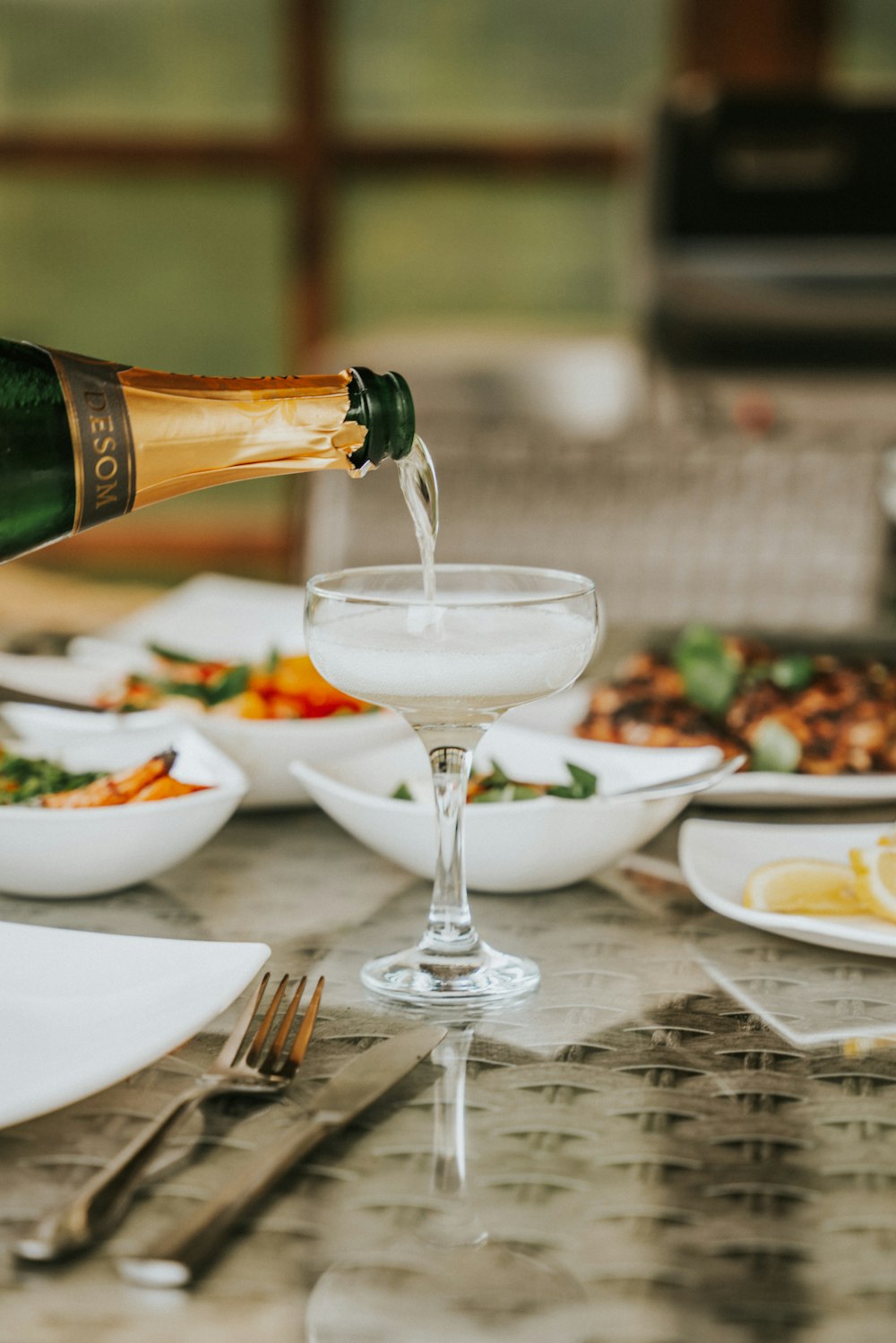 a glass of wine and a bottle of wine on a table