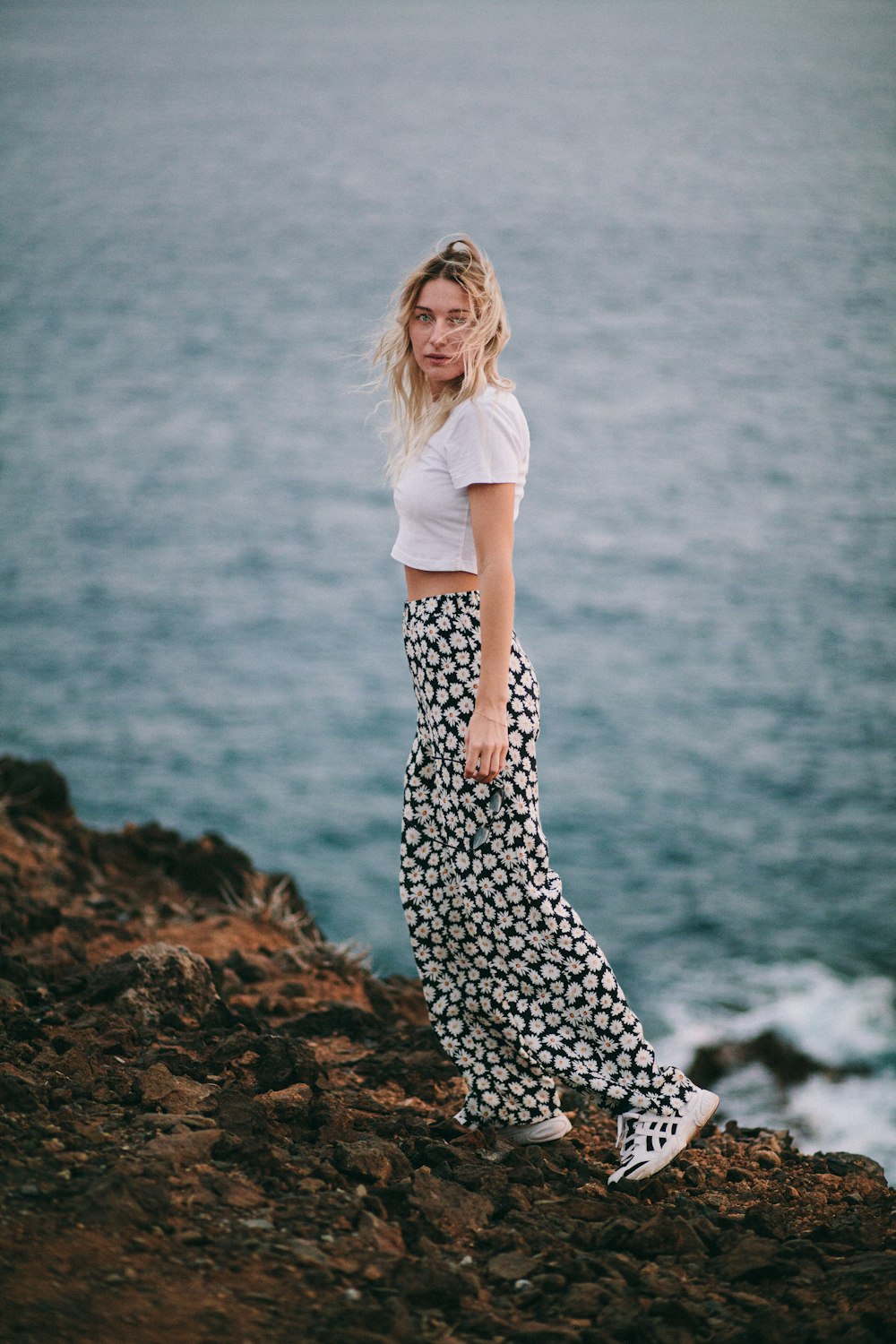 a person standing on a rocky shore