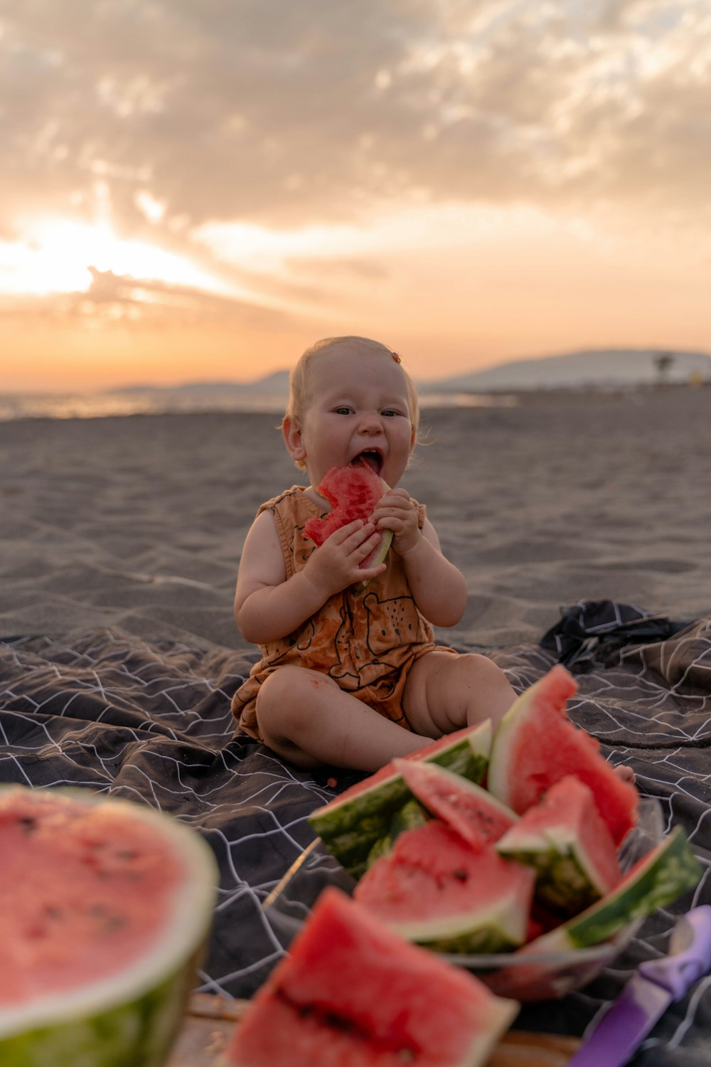 a baby eating watermelon