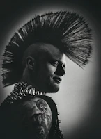 A mohawk hairstyle silhouette against a graffiti wall, showcasing the band's youthful spirit.