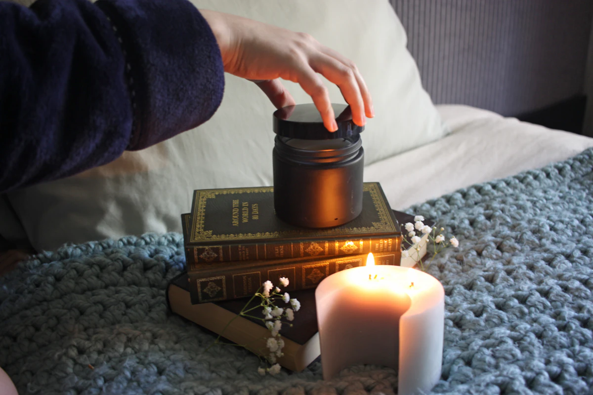 A person resting quietly by a candle, recharging energy