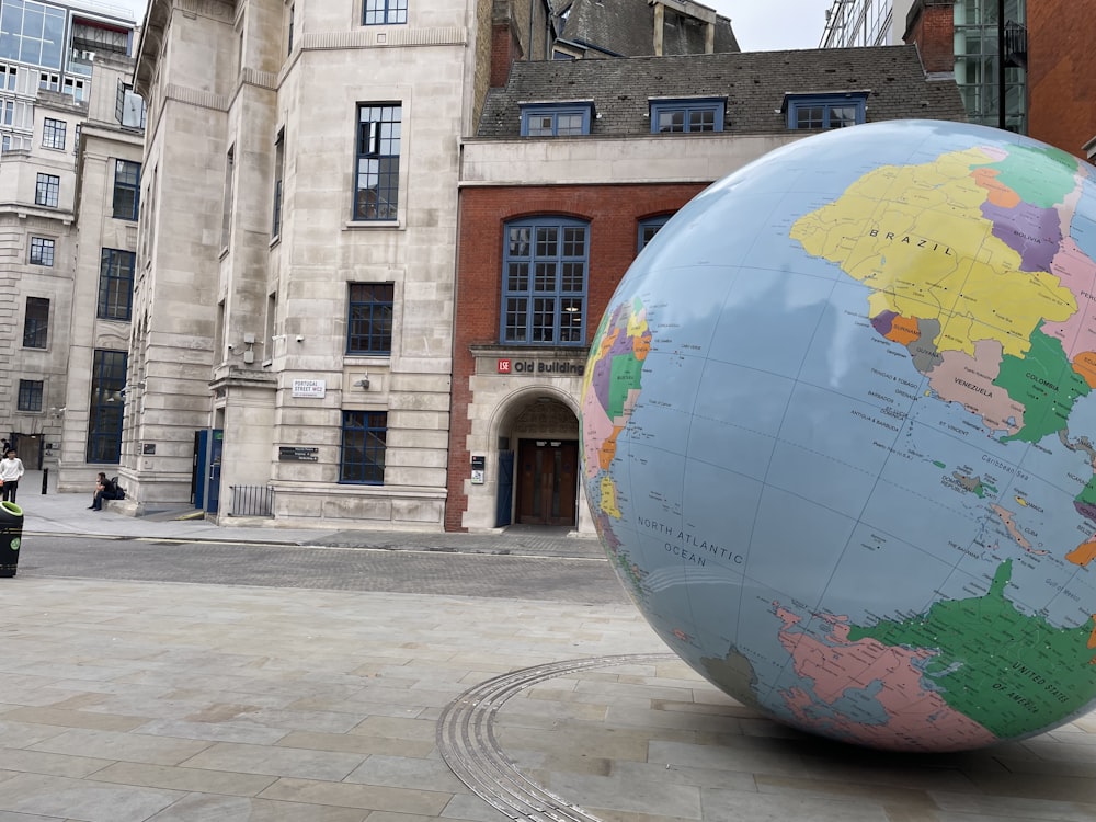 a large globe in front of a building