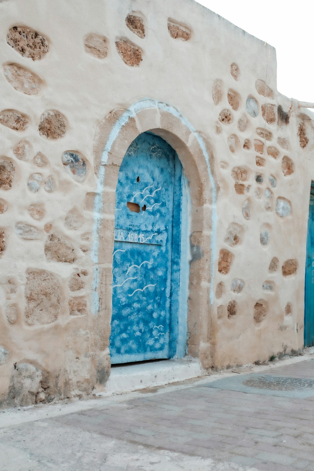 a blue door on a stone building
