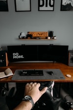 a person's feet on a desk with a computer and a keyboard