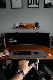 a person's feet on a desk with a computer and a keyboard