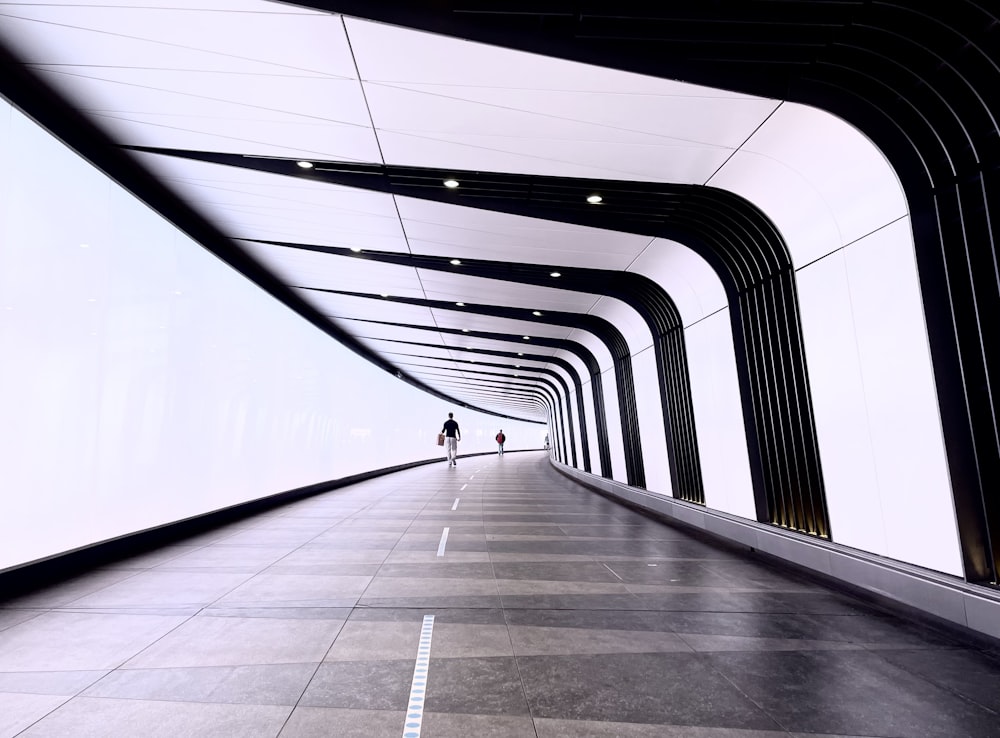 a couple people walking on a bridge