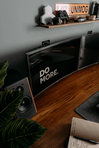 Close-up of a digital print with an uplifting message framed on a wooden desk.