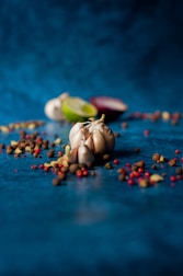 Close-up of fresh ingredients and spices arranged on a kitchen counter.