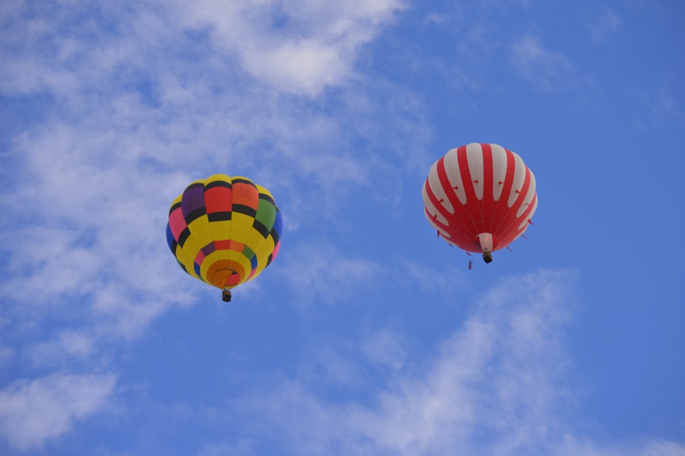 a couple of hot air balloons in the sky