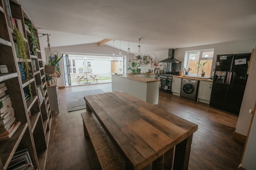 a kitchen with a table and shelves