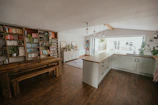 Bright family kitchen with warm tones, a large dining table, and cozy lighting.