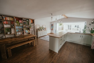 a kitchen with a book shelf