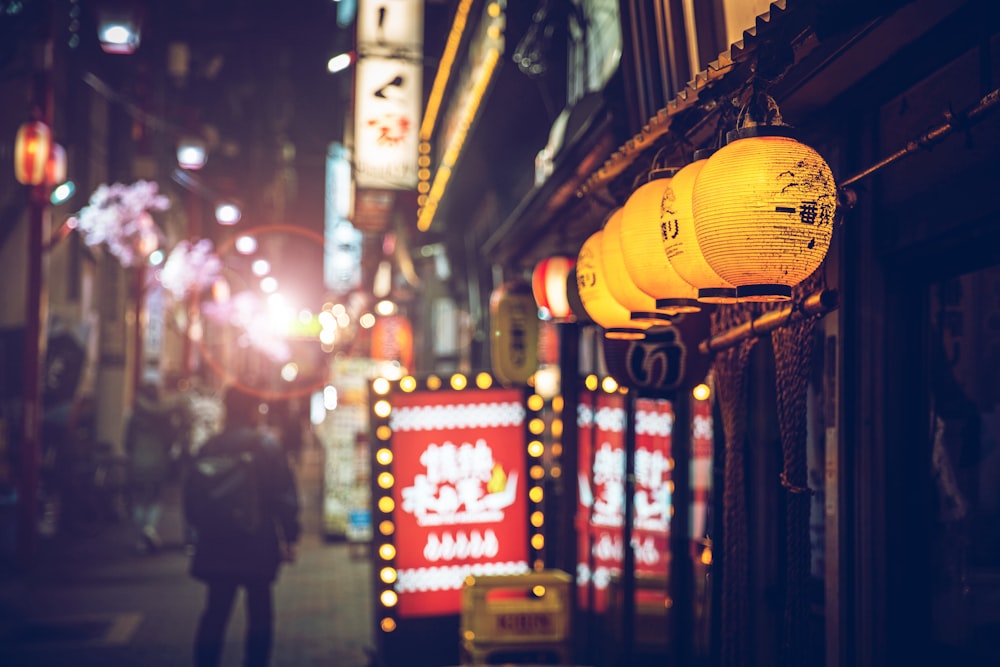 a street with lanterns from the ceiling