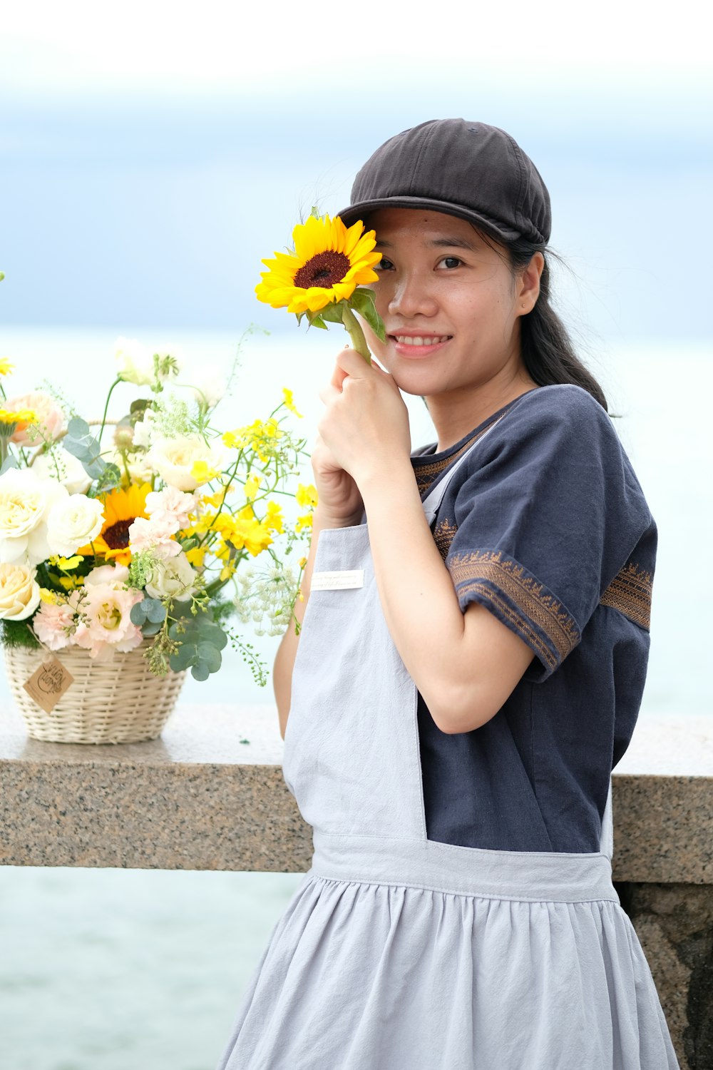 a woman holding a yellow flower