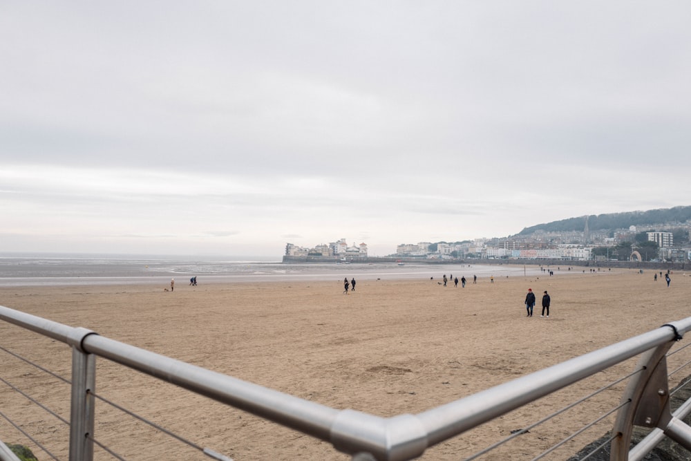 a group of people walking on a beach