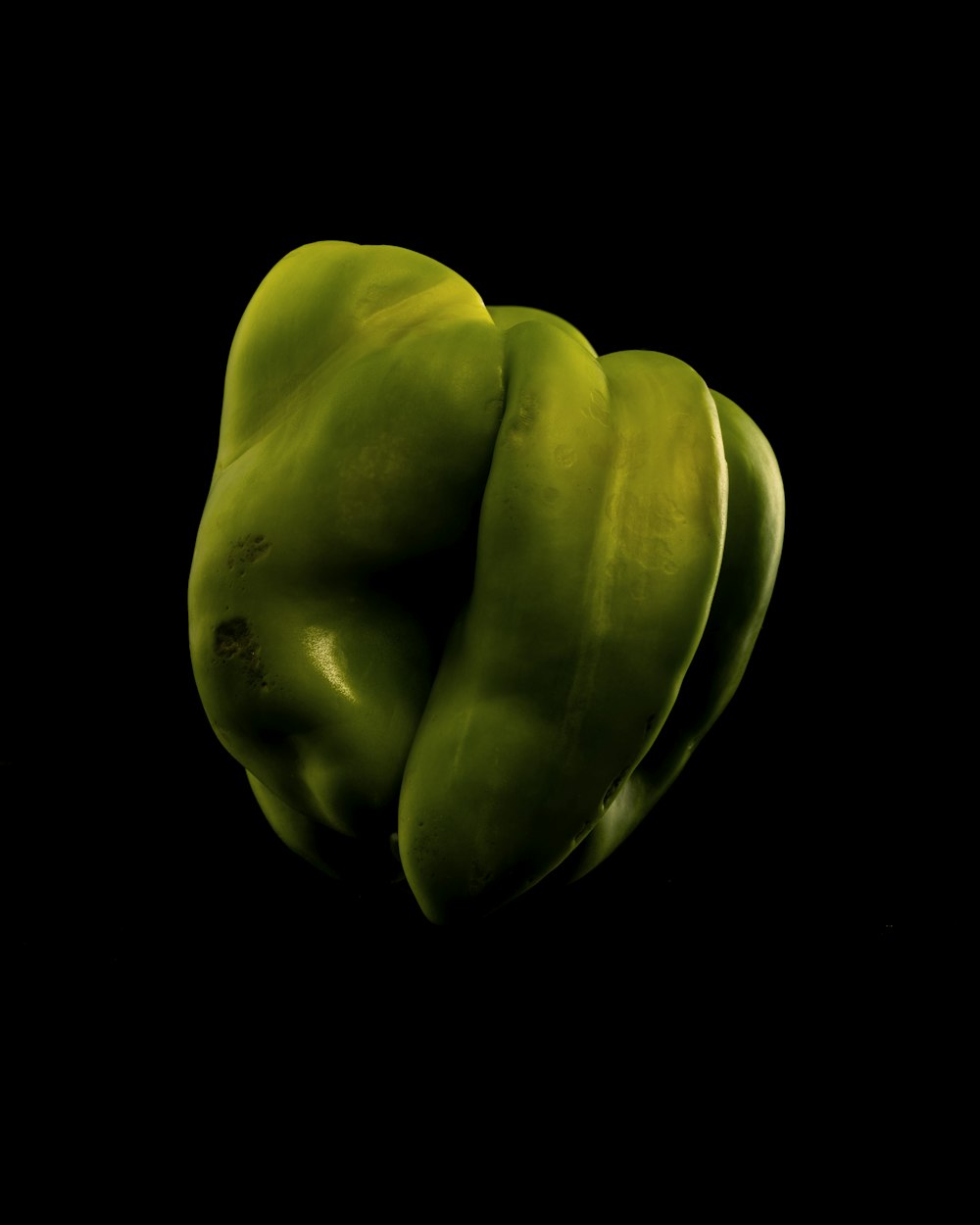 a green vegetable with a black background