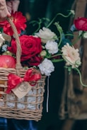 An elegant flower basket with colorful blooms and a gift box