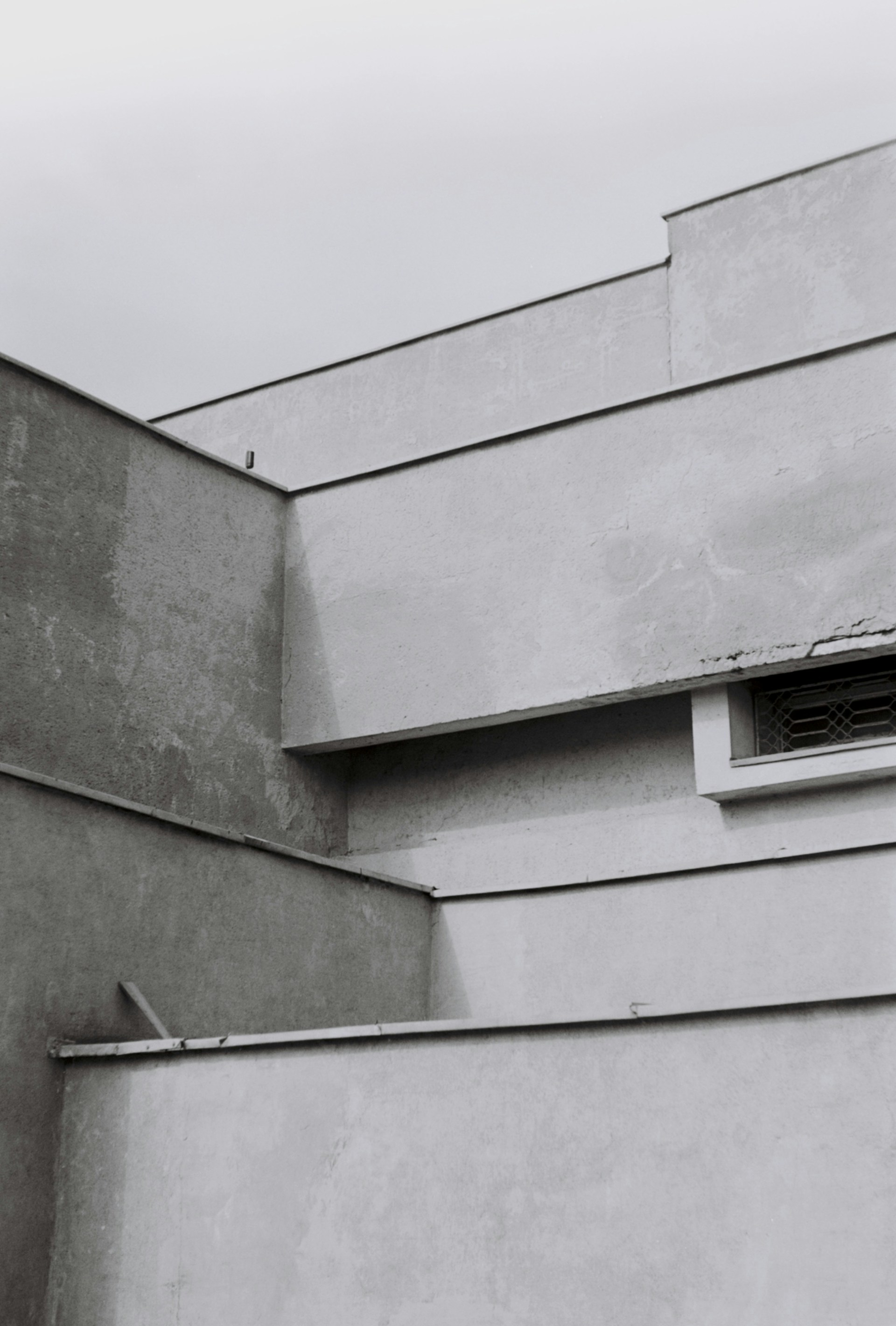 a grey building with a vent