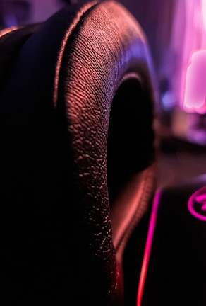 Close-up of a charcoal leather jacket's smooth texture under soft lighting.