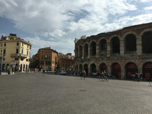 A large stone building with people walking around — Verona, Italy