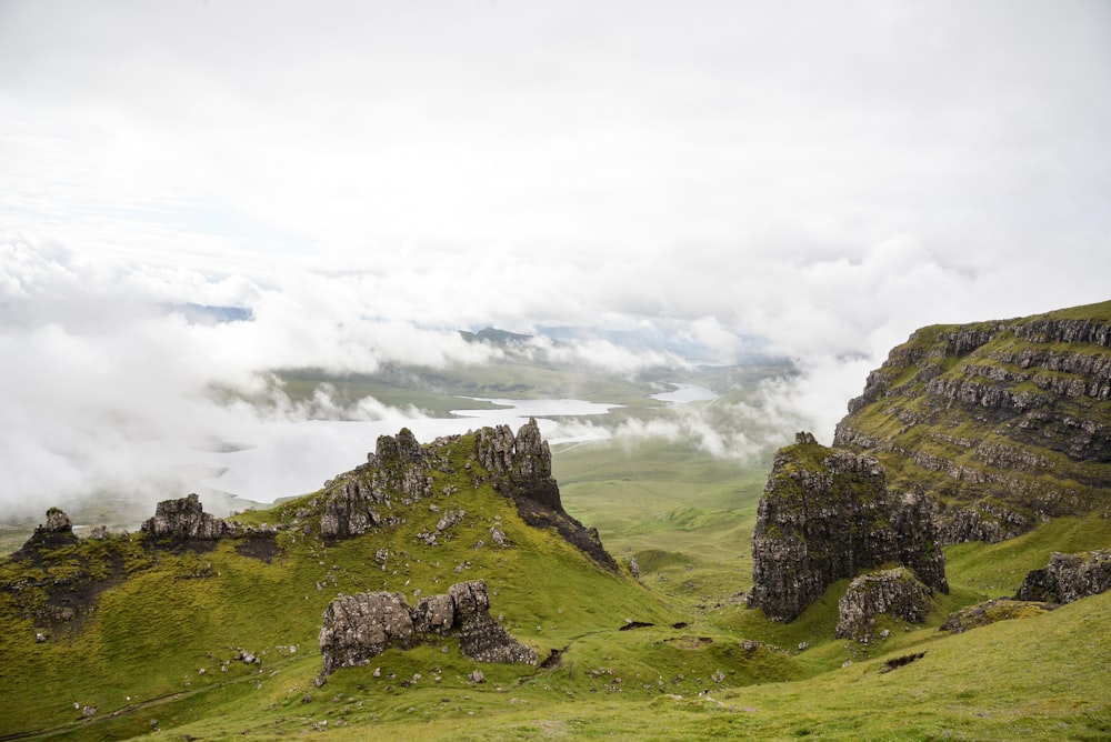 a grassy hill with rocks on it