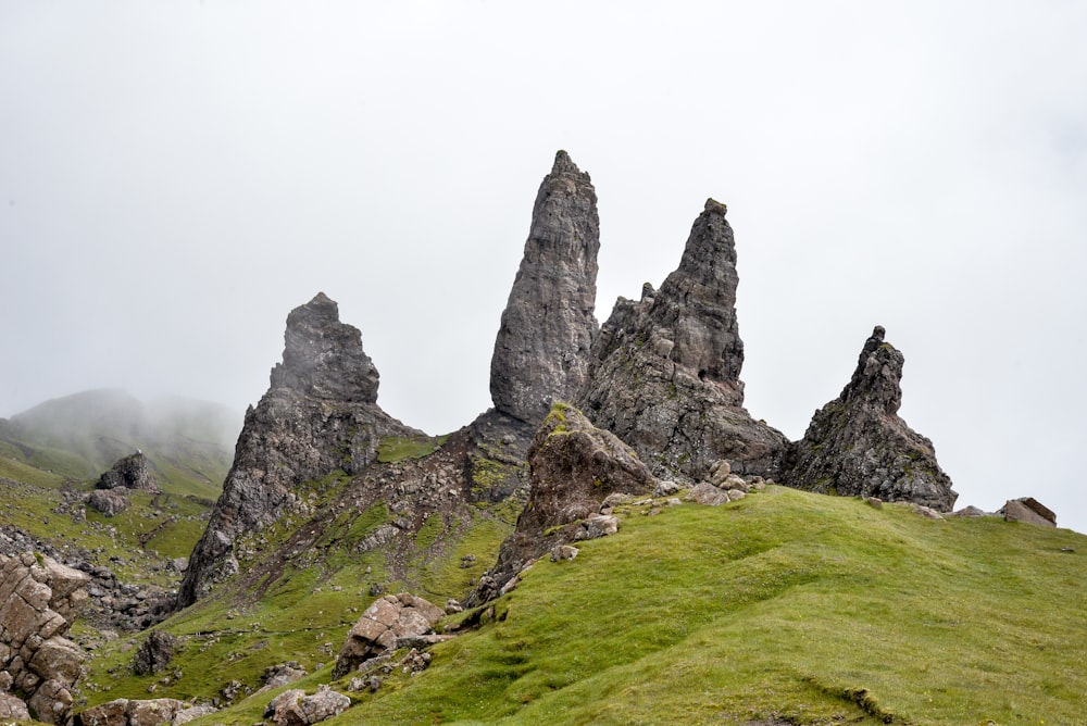 a grassy hill with large rocks on it