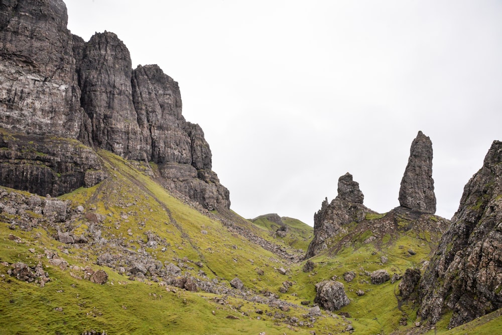 a grassy hill with large rocks on it