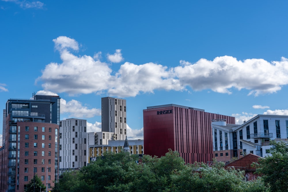 a group of buildings with trees in front of them