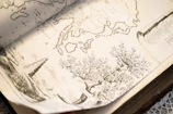 A shadowy, intricate map sketch revealing the mysterious world of a novel.