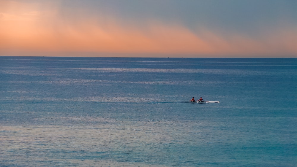 a couple people in a boat in the water