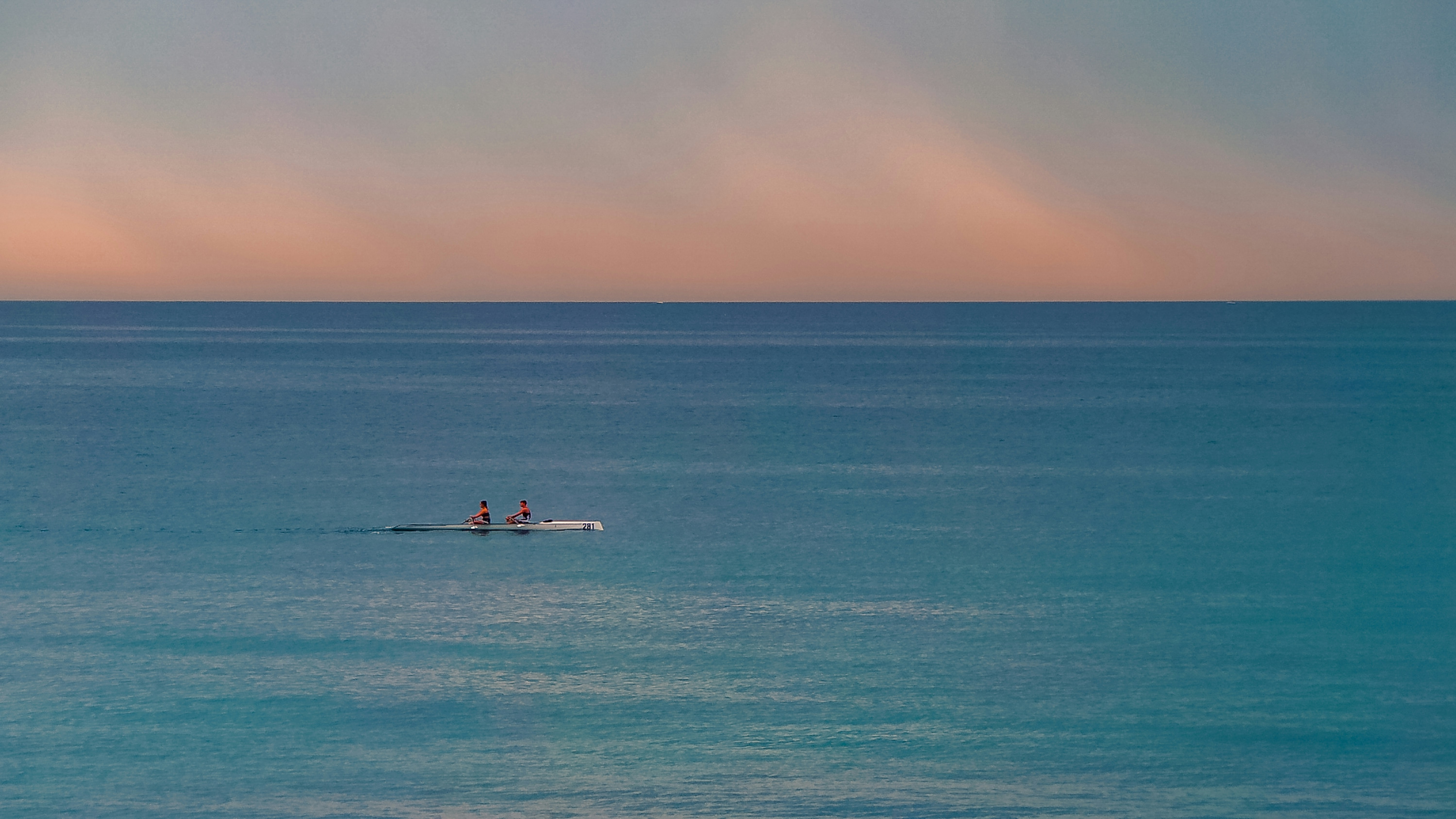 A coastal rowing boat on open water